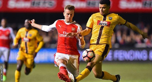 Arsenal's Rob Holding and Sutton's Maxime Biamou challenge for the ball during their FA Cup tie in February