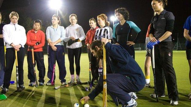 Women getting coached at hockey