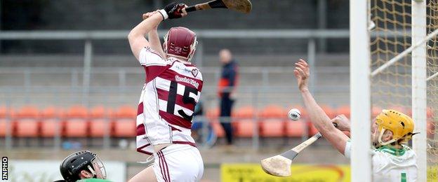 Slaughtneil's Brian Cassidy attempts to divert a long ball past Ballygalget keeper Jamie Crowe