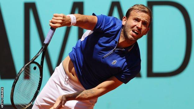 Dan Evans serves in his Madrid Open win against John Millman