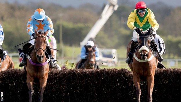 Un De Sceaux loses ground on Fox Norton (right) as they jump the final fence