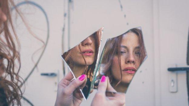 Woman looking in mirror