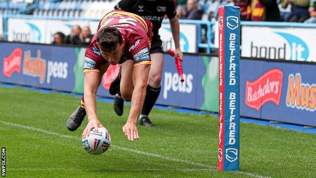 Louis Senior takes to the air to score for Huddersfield