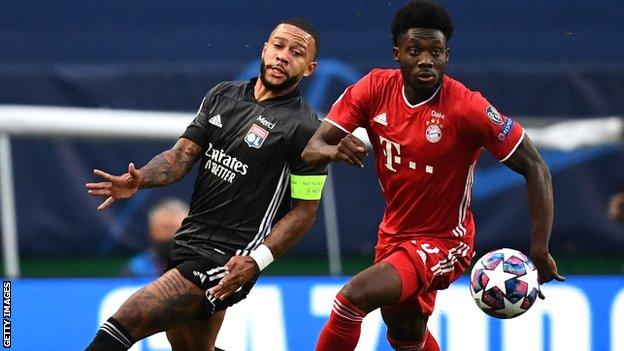 Alphonso Davies (right) in action for Bayern against Lyon