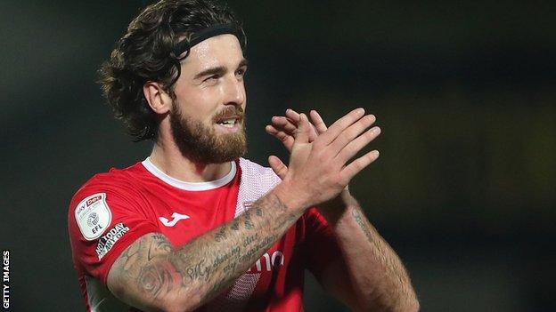 Morecambe striker Cole Stockton applauds