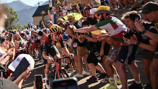 Fans cheer on stage winner Tom Pidcock as he makes his way up Alpe d'Huez