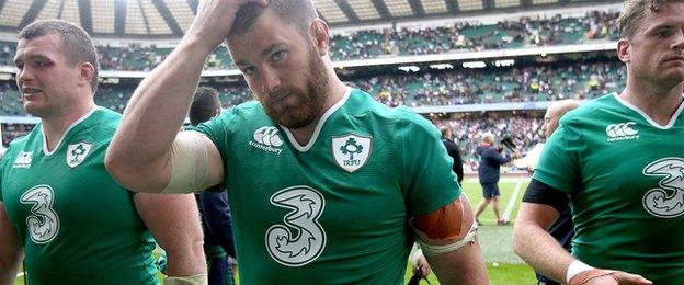 Jack McGrath, Sean O'Brien and Jamie Heaslip trudge off the pitch at Twickenham after Ireland's defeat by England