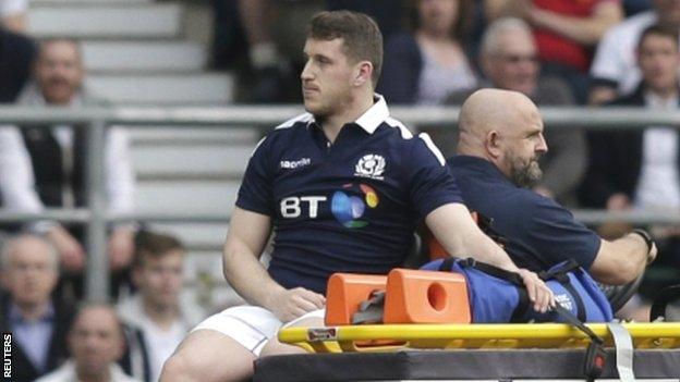 Scotland centre Mark Bennett is taken off on a cart at Twickenham