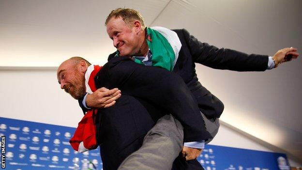 Jamie Donaldson jumps on the back of Thomas Bjorn after Europe's win in the 2014 Ryder Cup