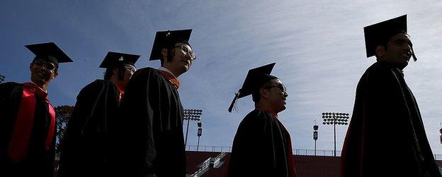 Stanford University students walk before the 2015 commencement ceremony.