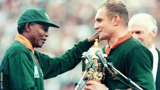 The image of Mandela handing the Rugby World Cup to Pienaar - an iconic image of South African sport