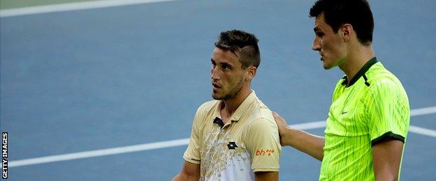 Damir Dzumhur of Bosnia and Herzegovina shakes hands with Bernard Tomic of Australia