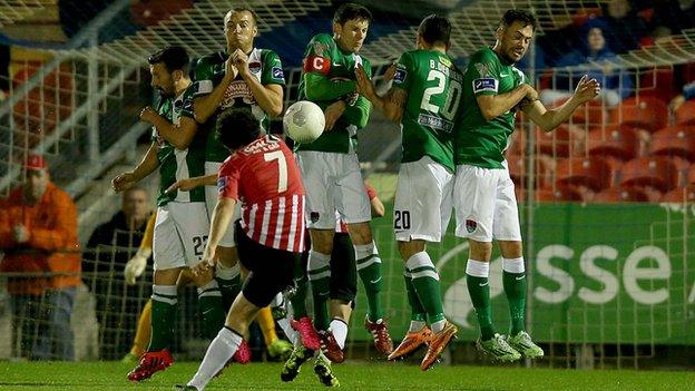 Derry midfielder Barry McNamee bends his free-kick over the Leesiders wall