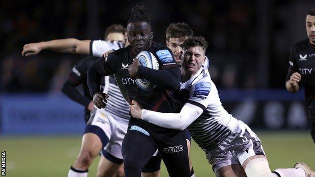 Sale winger Byron McGuigan was successful with this tackle on opposite number Rotimi Segun - but he got it wrong with his later challenge on Nick Tompkins