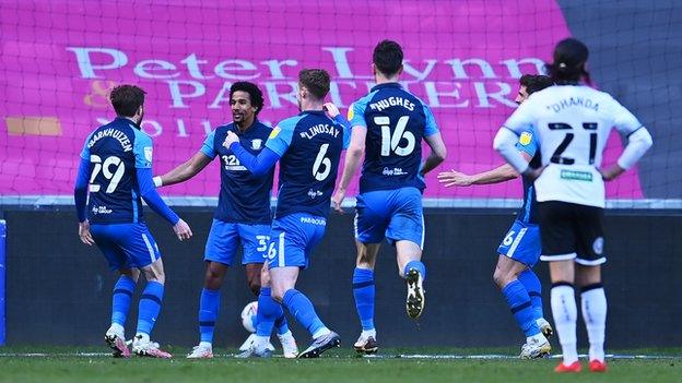 Scott Sinclair celebrates with Preston team-mates after their winning goal at Swansea City