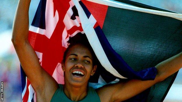 Cathy Freeman in 1994 with both the Australia and Aboriginal flags after winning the 400m final during the Commonwealth Games in Victoria, Canada