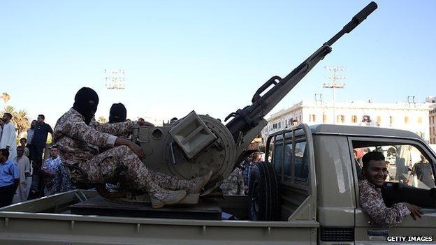 Soldiers march during a military parade to mark fourth anniversary of revolt which ousted dictator Muammar Gaddafi