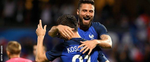 Laurent Koscielny and Olivier Giroud celebrate for France against Scotland