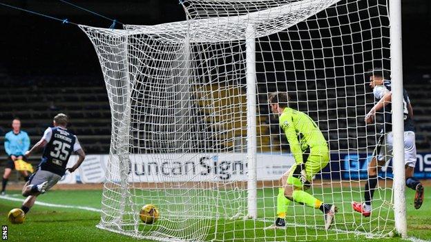 Jason Cummings (left) wheels away after scoring for Dundee