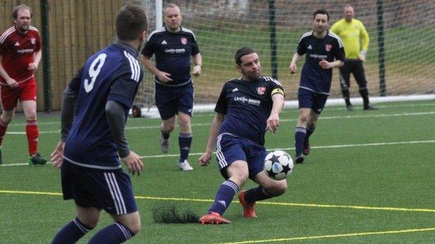 Rob McPherson playing for the Village Manchester football team