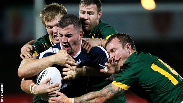 Scotland's Adam Walker is tackled against Australia