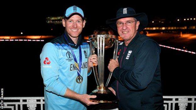 England captain Eoin Morgan (left) and coach Trevor Bayliss (right) hold up the World Cup trophy