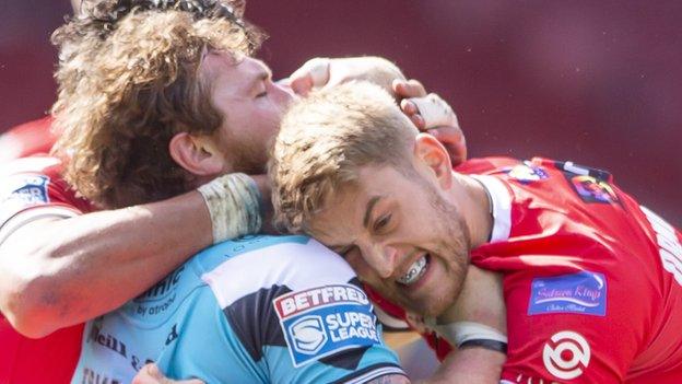 Lee Mossop tackles Scott Taylor with his mouthguard showing