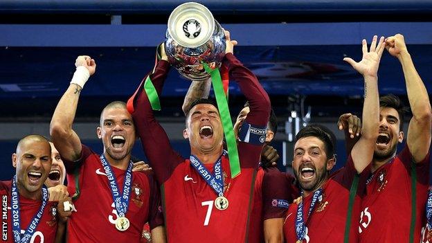 Portugal captain Cristiano Ronaldo raises the Euro 2016 trophy surrounded by team-mates