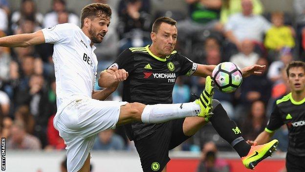 John Terry (right) in action against Swansea