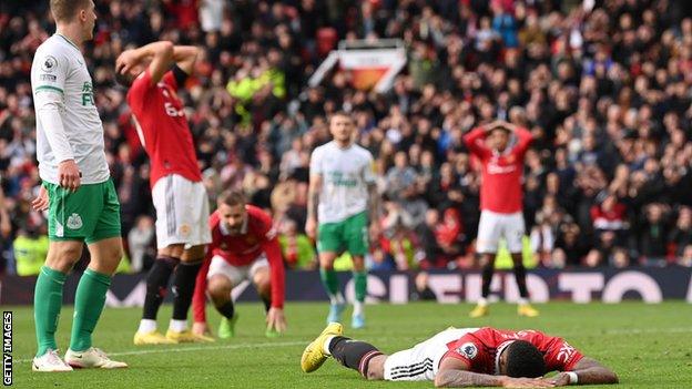 Marcus Rashford lies on the ground after missing a header in stoppage time