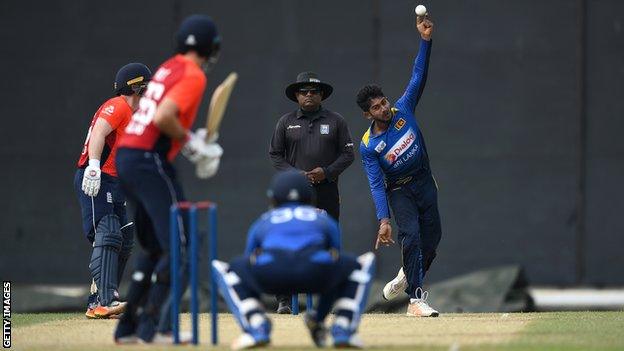 Sri Lanka's Kamindu Mendis bowls slow left-arm to England batsman Joe Root