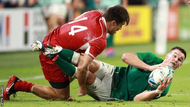 Johnny Sexton is tackled by German Davydov in Kobe