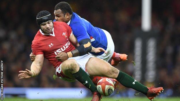 Wales' Leigh Halfpenny is tackled by Virimi Vakatawa