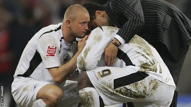 Lee Trundle (left) and Roberto Martinez (suited) console Adebayo Akinfenwa after his missed penalty for Swansea in the 2006 League One play-off final loss to Barnsley