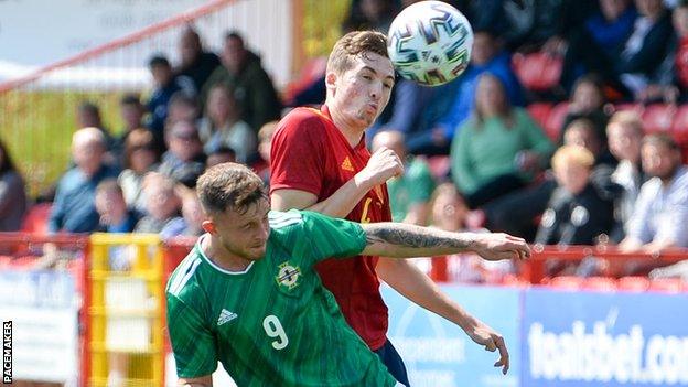 Northern Ireland's Dale Taylor is beaten to the high ball in Friday's qualifier