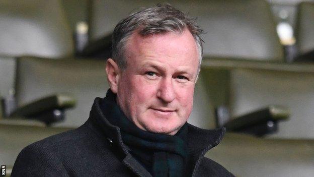 Michael O'Neill watches a Scottish Premiership match