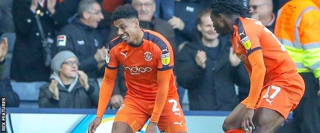 Luton's James Justin (left) celebrates a goal