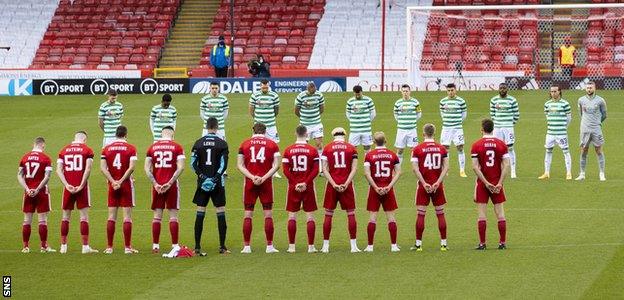 Aberdeen and Celtic players observe a minute's silence