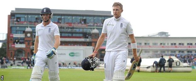 England's Jos Buttler and Joe Root walk off