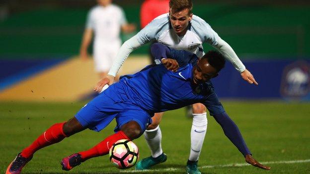 Moussa Dembele of France Under-21s and Rob Holding of England Under-21s