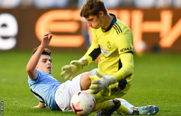 Manchester City's Alexander Robertson (left) in action against Manchester United's Under-23s