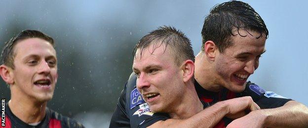 Andrew Mitchell of Crusaders is congratulated after scoring the first goal against Dungannon Swifts