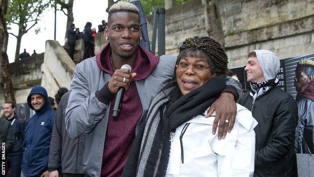 Paul Pogba and his mother Yeo at a promotional event in front of the Eiffel Tower in April