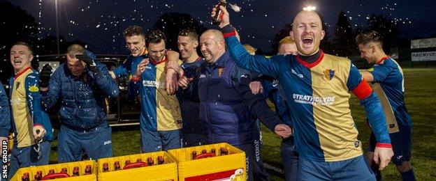 East Kilbride captain Barry Russell (right) celebrates with the beer brought from Amsterdam