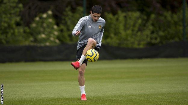 Pedro Neto practises with a football