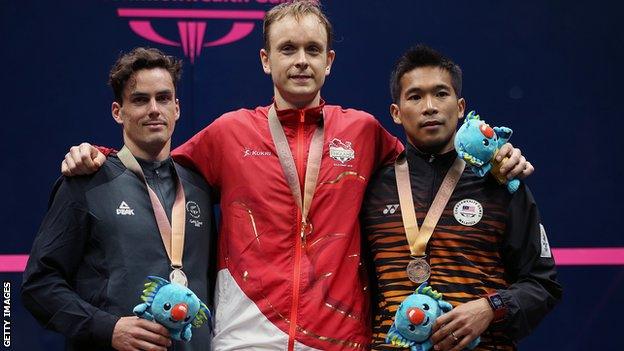 Silver-medal winner Paul Coll, left, alongside gold-medal winner James Willstrop, middle, and Nafiizwan Adnan, right, who won bronze for Malaysia