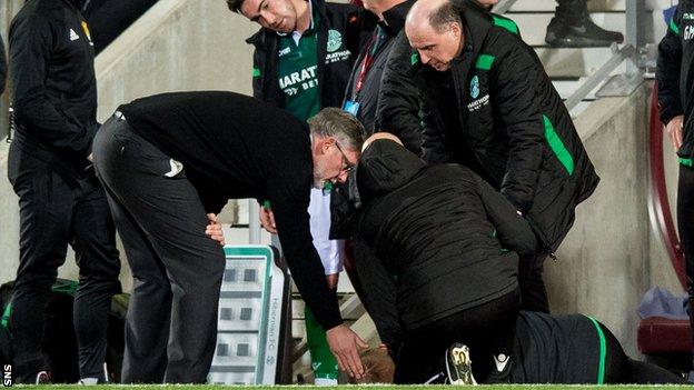 Hearts manager Craig Levein checks Neil Lennon's condition at Tynecastle