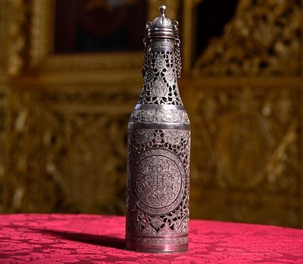 Silver urn containing chrism oil