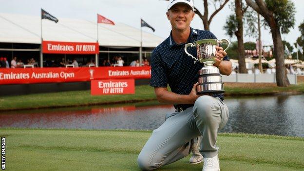 Matt Jones celebrates with the Australian Open trophy in December 2019