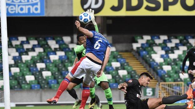 Linfield defender Jimmy Callacher is denied by Floriana keeper Ini Akpan